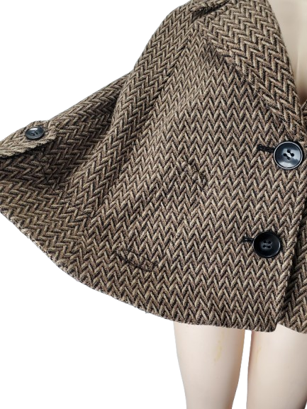 Brown herringbone patterned coat on a mannequin with a white background
