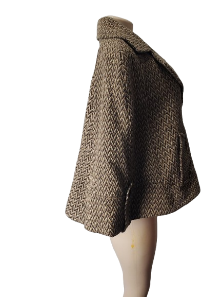 Brown herringbone patterned coat on a mannequin against a white background
