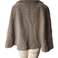 Brown patterned cape on a mannequin against a white background