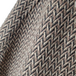 Close-up of a textured fabric with a herringbone pattern