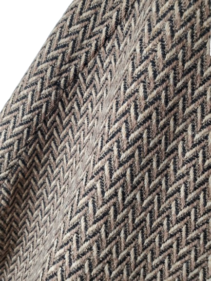 Close-up of a textured fabric with a herringbone pattern