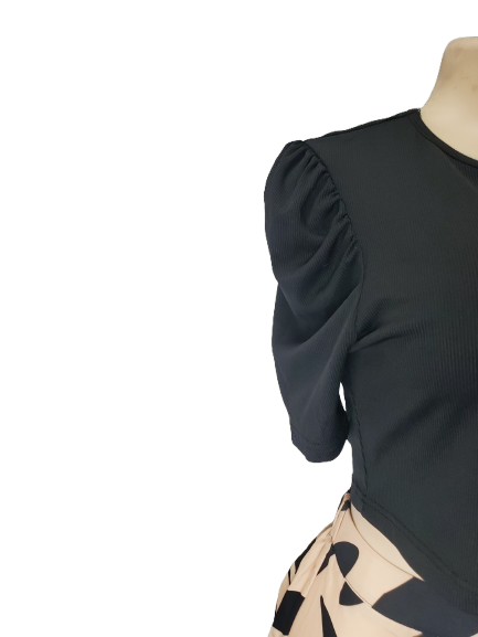 Black top with puff sleeves on a mannequin against a white background