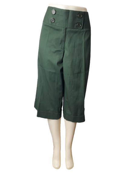 Green capri pants on a mannequin against a white background