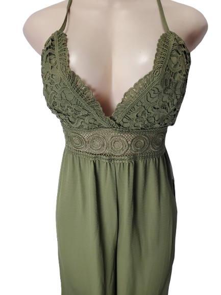 Green jumpsuit with lace detailing on a mannequin against a white background