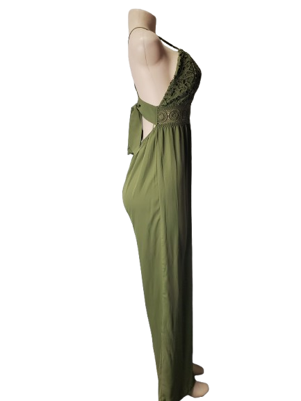 Green evening jumpsuit on a mannequin against a white background