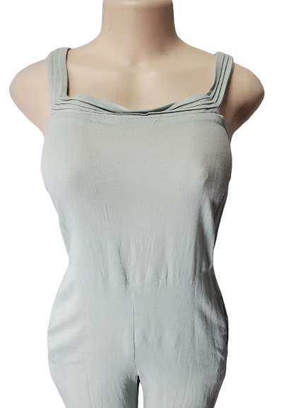Light green sleeveless jumpsuit on a mannequin against a white background