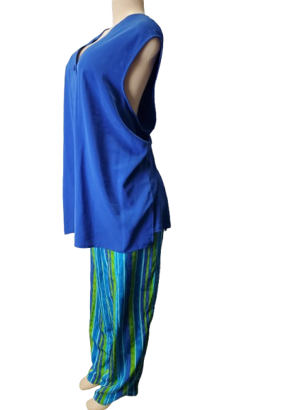 Blue top and colorful pants on a mannequin against a white background