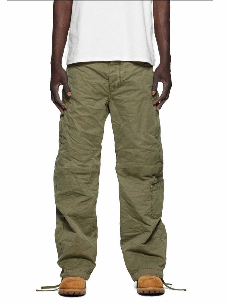 Person wearing green cargo pants and white shirt on a white background