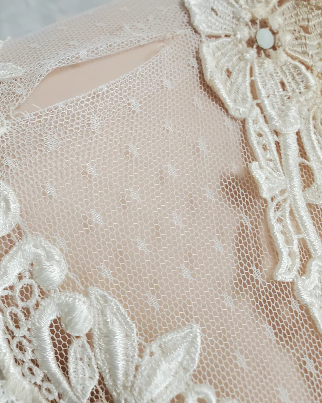Close-up of a lace garment with floral details